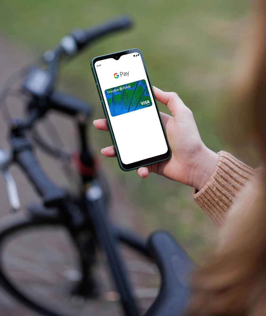 Smartphone showing Triodos debit card and Google Pay logo